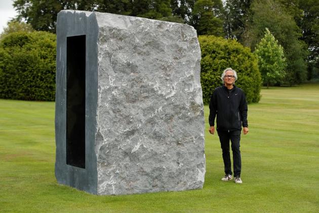 British-Indian artist Anish Kapoor poses with his sculpture in the gardens at Houghton Hall in Norfolk, Britain July 9, 2020. With Britain’s coronavirus lockdown eased, sculptor Anish Kapoor can finally exhibit his work at Houghton Hall, one of the country’s best-known stately homes. (REUTERS)