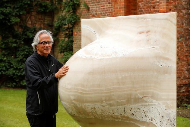 British-Indian artist Anish Kapoor poses with his sculptures in the gardens at Houghton Hall in Norfolk, Britain July 9, 2020. (REUTERS)