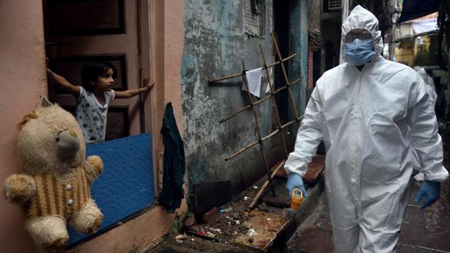 A child looks at a BMC health care worker out on a screening exercise in Mumbai on July 16. On the same day, Maharashtra’s overall Covid-19 infections crossed the 3 lakh mark and climbed to 300,937 with the addition of 8,348 new patients. At least 144 people succumbed to the disease, taking the death toll in the state to 11,596. (Satish Bate / HT Photo)