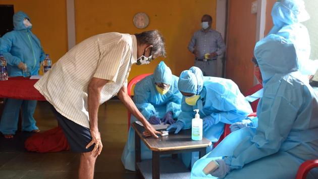 A BMC health care worker checks the blood oxygen levels of a Mandala Village resident in Mumbai on July 17. The case fatality rate (CFR), however, has remained a constant worry for the state, as it stands at 3.85%, second only to Gujarat (4.54%), and more than the national CFR of 2.53%. (Satish Bate / HT Photo)