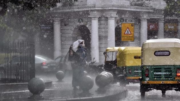 People take cover while it rains at Rajiv Chowk in New Delhi on Friday, July 17, 2020. (Photo by Mohd Zakir/ Hindustan Times) (Hindustan Times) People take cover while it rains at Rajiv Chowk in New Delhi on Friday, July 17, 2020. (Photo by Mohd Zakir/ Hindustan Times) (Hindustan Times)
