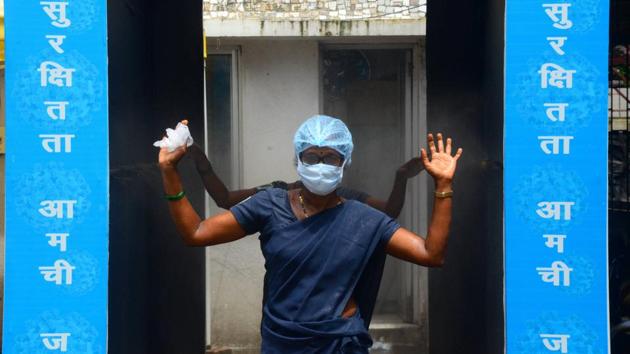 Staff members pass through a disinfecting tunnel at NMMC COVID-19 Hospital at Vashi in Mumbai on July 18. With 5,650 deaths, Mumbai accounts for 48.7% of the state’s deaths as of July 18. The city’s recovery rate at 70% however stands significantly higher than Maharashtra’s 55.05%. (PTI)