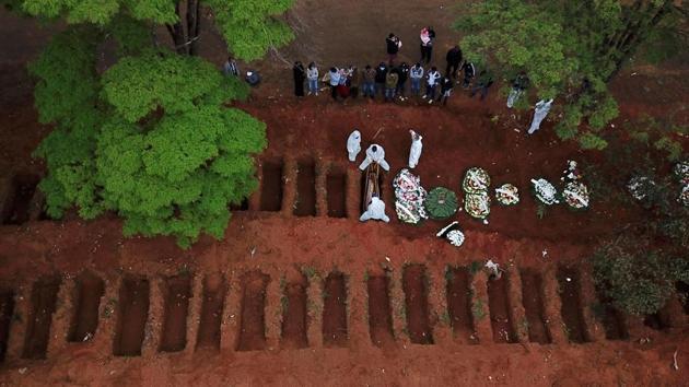 Gravediggers wearing protective suits bury a coffin at Vila Formosa cemetery in Sao Paulo on July 16. The country took four months to cross a million Covid-19 cases on June 19 after recording its first case on February 26. The second million took just 28 days. Since late May, the country has recorded more than 1,000 daily deaths on average, AP reported. (Amanda Perobelli / REUTERS)