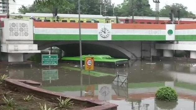 A DTC bus submerged in water under the Minot Bridge in New Delhi following heavy rain on Sunday morning.(ANI Photo)