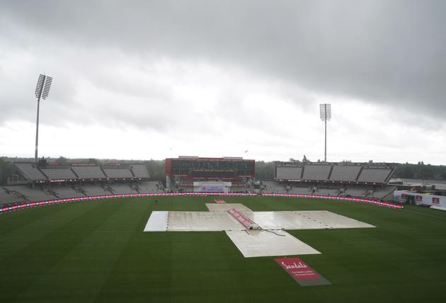 Clouds loom over as the pitch area is seen covered after rain delayed start of the third day of the second cricket Test match between England and West Indies at Old Trafford in Manchester, England, Saturday, July 18, 2020. (AP Photo/Jon Super, Pool) (AP)