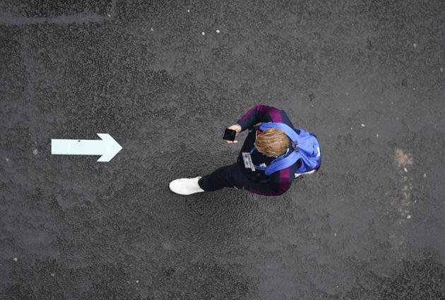 England's Ben Stokes holds his mobile phone as he walks next to the field after rain delayed start of the third day of the second cricket Test match between England and West Indies at Old Trafford in Manchester, England, Saturday, July 18, 2020. (AP Photo/Jon Super, Pool) (AP)