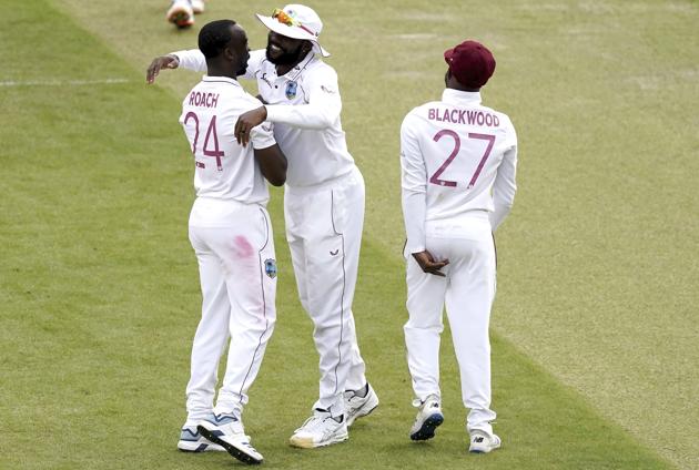 West Indies' Kemar Roach, left, celebrates with teammates the dismissal of England's Ben Stokes during the second day of the second cricket Test match between England and West Indies at Old Trafford in Manchester, England, Friday, July 17, 2020. (AP Photo/Jon Super, Pool) (AP)