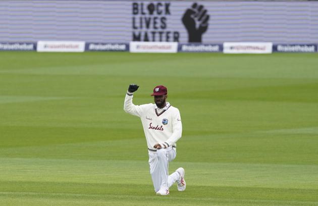 West Indies' Roston Chase takes a knee before the start of the first day of the second cricket Test match between England and West Indies at Old Trafford in Manchester, England, Thursday, July 16, 2020. (AP Photo/Jon Super, Pool) (AP) West Indies' Roston Chase takes a knee before the start of the first day of the second cricket Test match between England and West Indies at Old Trafford in Manchester, England, Thursday, July 16, 2020. (AP Photo/Jon Super, Pool) (AP)