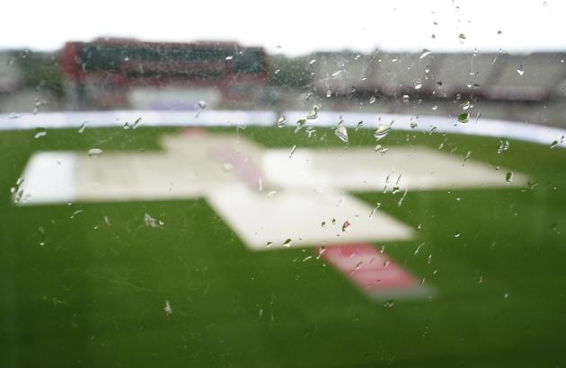 The covered pitch area is seen through a glass after rain delayed start of the third day of the second cricket Test match between England and West Indies at Old Trafford in Manchester, England, Saturday, July 18, 2020. (AP Photo/Jon Super, Pool) (AP)