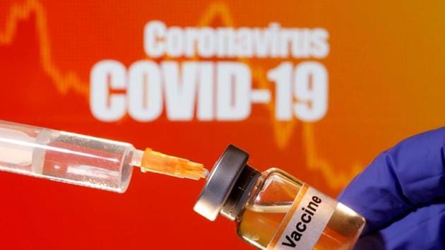 A small bottle labelled with a ‘Vaccine’ sticker is held near a medical syringe in front of displayed ‘Coronavirus Covid-19’ words in this illustration. (Representative Photo/Reuters) A small bottle labelled with a ‘Vaccine’ sticker is held near a medical syringe in front of displayed ‘Coronavirus Covid-19’ words in this illustration. (Representative Photo/Reuters)