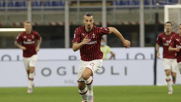 AC Milan's Zlatan Ibrahimovic runs withe ball during a Serie A soccer match between AC Milan and Bologna, at the San Siro stadium in Milan, Italy, Saturday, July 18, 2020. (AP Photo/Luca Bruno)(AP)