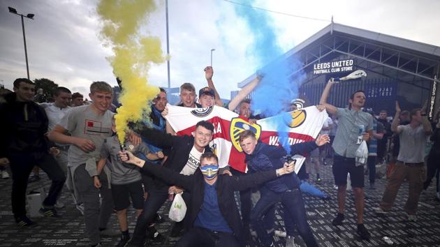 Leeds United fans celebrate outside Elland Road, Friday, July 17, 2020, on Leeds, England, after Huddersfield Town beat West Bromwich Albion to seal their promotion to the Premier League.(AP)