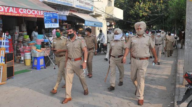 Police personnel holding a flag march at the Burail market in Sector 45, Chandigarh, on Monday.(Ravi Kumar/HT) Police personnel holding a flag march at the Burail market in Sector 45, Chandigarh, on Monday.(Ravi Kumar/HT)