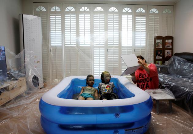Children play in a mud pool during the Online Boryeong Mud Festival at their home during a live streaming event, in Gwangju, Gyeonggi-do, South Korea, July 18, 2020. (REUTERS) Children play in a mud pool during the Online Boryeong Mud Festival at their home during a live streaming event, in Gwangju, Gyeonggi-do, South Korea, July 18, 2020. (REUTERS)
