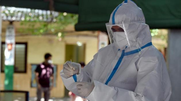 A health worker conducts a coronavirus test, from the collected swab samples, at Turkman Gate, in New Delhi.(Sonu Mehta/HT PHOTO) A health worker conducts a coronavirus test, from the collected swab samples, at Turkman Gate, in New Delhi.(Sonu Mehta/HT PHOTO)
