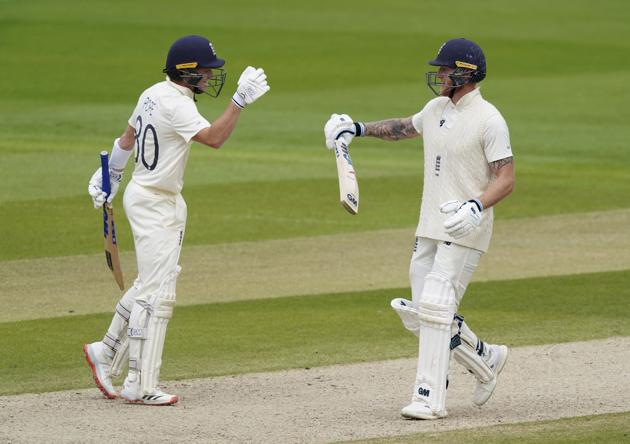 England's Ben Stokes, right, celebrates with teammate Ollie Pope after hitting a boundary. (AP)