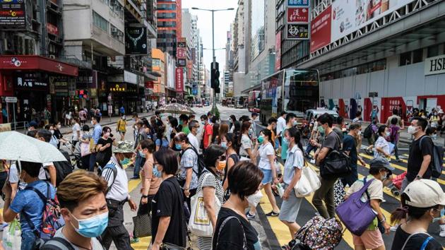 Pedestrians walk across a main road in Hong Kong on July 20. Hong Kong has reimposed tough social distancing measures after officials confirmed a single-day record high of 108 new conformed cases of Covid-19 infections on July 19. (Anthony Wallace / AFP) Pedestrians walk across a main road in Hong Kong on July 20. Hong Kong has reimposed tough social distancing measures after officials confirmed a single-day record high of 108 new conformed cases of Covid-19 infections on July 19. (Anthony Wallace / AFP)