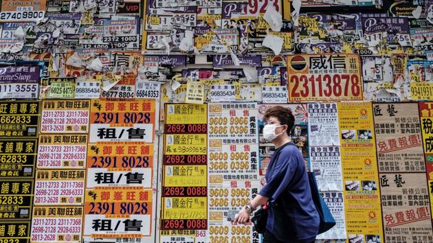 A pedestrian walks past a closed down shop plastered with advertising posters in Hong Kong on July 20. “The situation is very severe and there are no signs this is getting under control,” Lam said after viewing reports of mass testing conducted by the city government last week. (Anthony Wallace / AFP) A pedestrian walks past a closed down shop plastered with advertising posters in Hong Kong on July 20. “The situation is very severe and there are no signs this is getting under control,” Lam said after viewing reports of mass testing conducted by the city government last week. (Anthony Wallace / AFP)