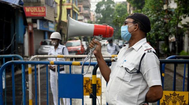 A Kolkata Police personnel speaks on the loudspeaker at Kankurgachi -- one of the new coronavirus containment zone in Kolkata, West Bengal. (Samir Jana /HT Photo) A Kolkata Police personnel speaks on the loudspeaker at Kankurgachi -- one of the new coronavirus containment zone in Kolkata, West Bengal. (Samir Jana /HT Photo)
