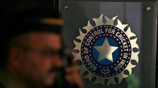 A policeman walks past a logo of the Board of Control for Cricket in India (BCCI) during a governing council meeting of the Indian Premier League (IPL) at BCCI headquarters in Mumbai.(REUTERS)