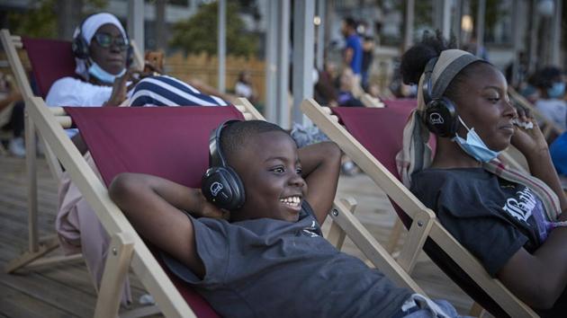 A young boy enjoys the comedy “Le Grand Bain”, at La Villette on July 18. Cinemas have reopened in France, but occupancy levels remain very low. While the virus has been under control with fatalities and the number of people in intensive care falling, daily cases have increased ahead of the summer holiday season, Reuters reported. (Kiran Ridley / Getty Images) A young boy enjoys the comedy “Le Grand Bain”, at La Villette on July 18. Cinemas have reopened in France, but occupancy levels remain very low. While the virus has been under control with fatalities and the number of people in intensive care falling, daily cases have increased ahead of the summer holiday season, Reuters reported. (Kiran Ridley / Getty Images)