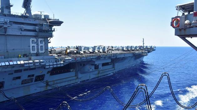 The US navy aircraft carrier USS Nimitz receives fuel from the Henry J Kaiser-class fleet replenishment oiler USNS Tippecanoe during an underway replenishment in the South China Sea, on July 7.(Reuters Photo)