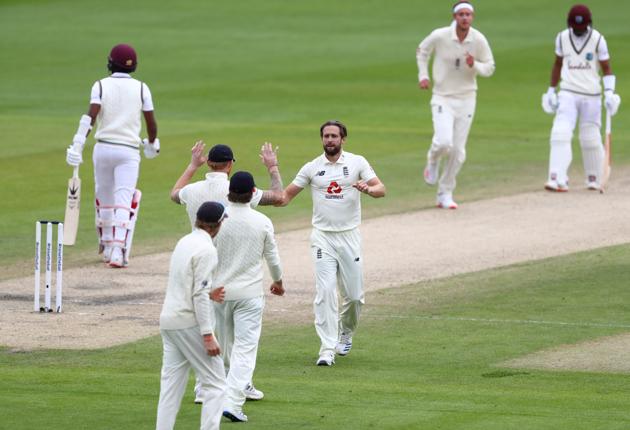 England's Chris Woakes celebrates the wicket of West Indies' Kraigg Brathwaite with teammates. (REUTERS)