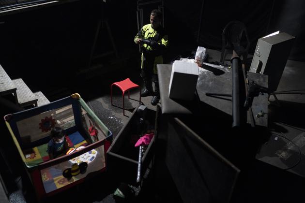 Anderson de Souza, the clown Batatinha, prepares to perform in the Globe of death as his 2-year-old son sits on a playpen at the Estoril Circus during the continuing coronavirus pandemic in Itaguai, greater Rio de Janeiro, Brazil, Saturday, July 18, 2020. (AP)