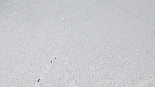 Alpinists walk on a glacier at the Aiguille du Midi near the Mont-Blanc in Chamonix, France, July 20, 2020. (REUTERS)
