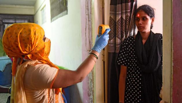 A health worker conducts thermal screening for Covid-19 at PNGE Colony in Dharavi, Mumbai on July 20. In addition to aggressive testing and lockdowns, the government’s move of drafting frontline health workers like Accredited Social Health Activists (ASHAs) and Auxiliary Nurse Mid-wives (ANMs) has been effective in conducting door-to-door surveillance and to create ground level awareness, HT reported. (Vijayanand Gupta / HT Photo) A health worker conducts thermal screening for Covid-19 at PNGE Colony in Dharavi, Mumbai on July 20. In addition to aggressive testing and lockdowns, the government’s move of drafting frontline health workers like Accredited Social Health Activists (ASHAs) and Auxiliary Nurse Mid-wives (ANMs) has been effective in conducting door-to-door surveillance and to create ground level awareness, HT reported. (Vijayanand Gupta / HT Photo)