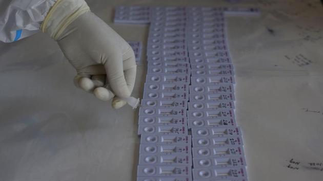 A health worker pours a sample into a Covid-19 rapid testing kit at a testing centre in Khajuri Khas, New Delhi on July 17. The results of the sero-prevalence study have shown that on an average, across Delhi, the prevalence of IgG [Immunoglobulin G] antibodies is 23.48 %.  (Vipin Kumar / HT Photo) 