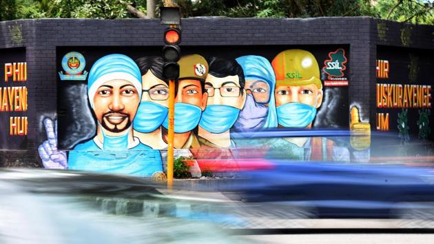 Trtaffic moves past a mural of Covid-19 front line workers at RK Puram in New Delhi on July 20. The Health Ministry had commissioned the sero-surveillance study in Delhi, which has a population of about 20 million, and was jointly conducted by the National Centre for Disease Control (NCDC) and the Delhi government between June 27 and July 10. (Sonu Mehta / HT Photo)