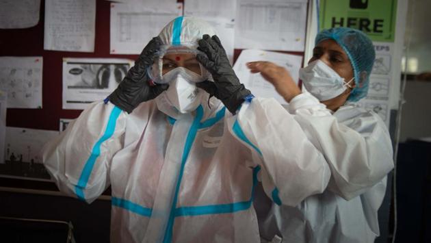 A health worker gears up inside the Common Wealth Games (CWG) Village Sports Complex which is temporarily converted into a Covid-19 care centre in Patparganj on July 19. Experts in community medicine say that since the samples were collected in end-June and the beginning of July, there is a possibility more people may have developed antibodies against the virus by now, HT reported. (Sanchit Khanna / HT Photo)