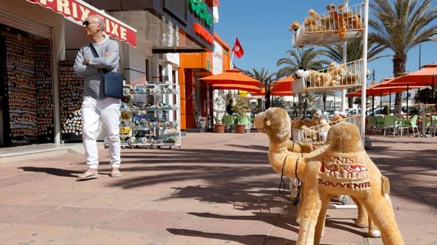 FILE PHOTO: A tourist walks past a souvenir shop in Hammamet, Tunisia March 12, 2020. (Representational)(REUTERS)
