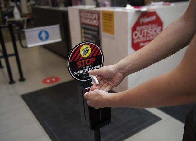 A member sanitizes their hands as they enter a GoodLife Fitness Centers Inc. gym on its first day of reopening in Ottawa, Ontario, Canada, on Friday, July 17, 2020. (Bloomberg)