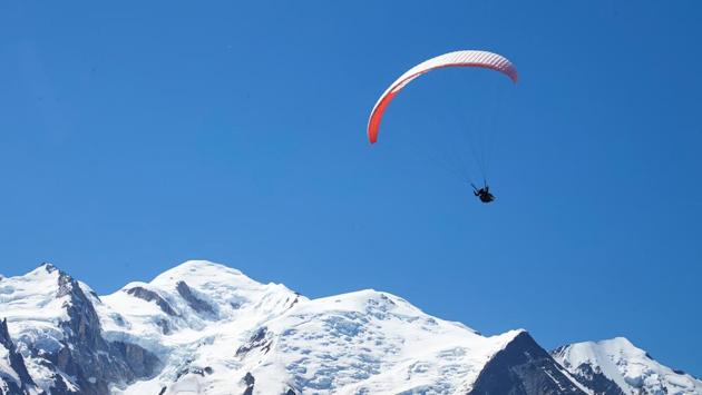 A paraglider flies over the Mont-Blanc mountain from Le Brevent in Chamonix, France, July 20, 2020. (REUTERS)