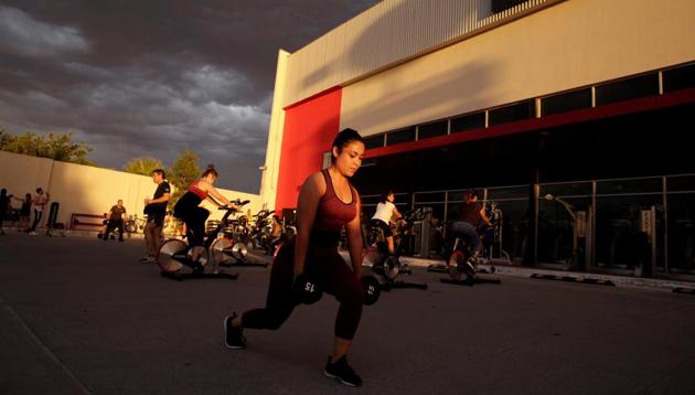 People exercise at the parking lot of a gym, where its fitness equipment was temporarily moved, as the government has not announced a reopening date for fitness centers, during the coronavirus disease (COVID-19) outbreak, in Ciudad Juarez, Mexico July 15, 2020. (via REUTERS)
