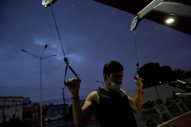 A man exercises outside a gym, where its fitness equipment was temporarily moved, as the government has not announced a reopening date for fitness centers, during the coronavirus disease (COVID-19) outbreak, in Ciudad Juarez, Mexico July 15, 2020. (via REUTERS)