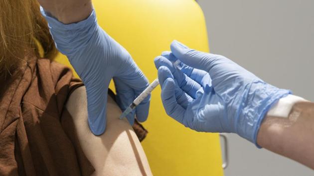 In this handout photo released by the University of Oxford a volunteer participates in the vaccine trial in Oxford, England on July 7, 2020.(AP)
