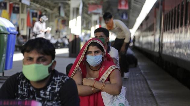 Migrant workers wait to board a special train to return during a nationwide lockdown to curb the spread of new coronavirus, at a railway station. (AP) Migrant workers wait to board a special train to return during a nationwide lockdown to curb the spread of new coronavirus, at a railway station. (AP)