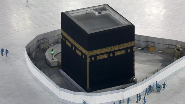 Workers disinfect the ground around the Kaaba, the cubic building at the Grand Mosque, over fears of the new coronavirus, the Muslim holy city of Mecca, Saudi Arabia. (AP) Workers disinfect the ground around the Kaaba, the cubic building at the Grand Mosque, over fears of the new coronavirus, the Muslim holy city of Mecca, Saudi Arabia. (AP)