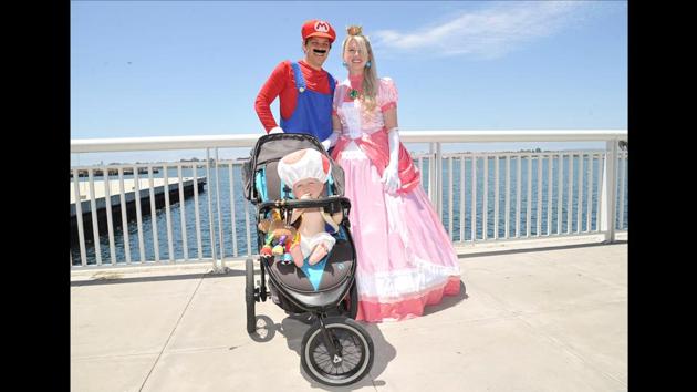 The Divis family dressed as Mario, Princess Peach and Toad from the Mario Bros. franchise, on day one of Comic-Con International in San Diego on July 18, 2019. (Shotwell/Invision/AP)