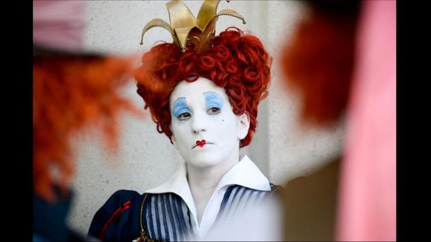 Lorraine Ouellette, dresses as a member of the League of Hatters, poses for a photograph in between two Mad Hatters on day one of Comic-Con International held at the San Diego Convention Centre on July 21, 2016. (Denis Poroy/Invision/AP)