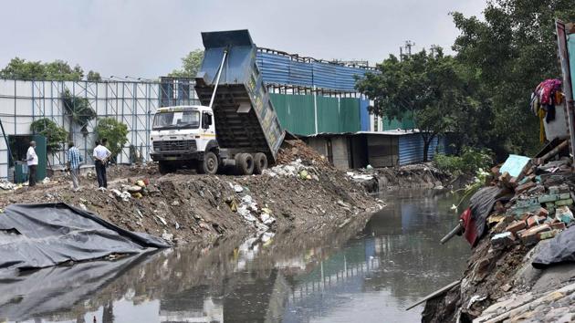 Repair work underway in Anna Nagar, where several houses had collapsed due to heavy rain in New Delhi on July 22. The season’s first heavy rains on July 19 had also claimed a life due to severe waterlogging when a 56-year-old man had drowned in the underpass at central Delhi’s Minto Bridge. (Sanjeev Verma / HT Photo)