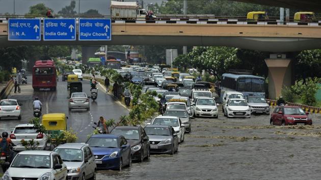 Commuters wade through a waterlogged road after a heavy spell of rain, at AIIMS in New Delhi on July 22. According to meteorologists, the spell of monsoon rain in Delhi is due to a combination of factors. The monsoon trough (line of low pressure) is passing south of Delhi. However, it is likely to shift to the east from July 23 onwards leading to a gradual reduction in rain. (Biplov Bhuyan / HT Photo)