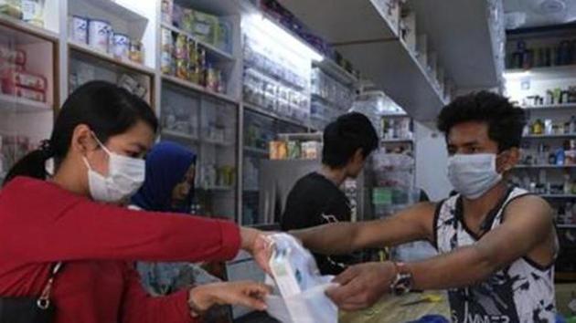A girl buys surgical masks amid Covid--19 outbreak in Imphal, capital of the northeastern Indian state of Manipur. (AP) A girl buys surgical masks amid Covid--19 outbreak in Imphal, capital of the northeastern Indian state of Manipur. (AP)