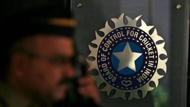 A policeman walks past a logo of the Board of Control for Cricket in India (BCCI).(REUTERS)