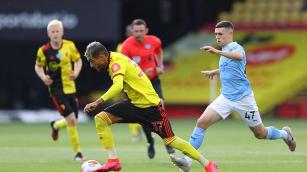 Watford's Roberto Pereyra in action with Manchester City's Phil Foden.(Pool via REUTERS)