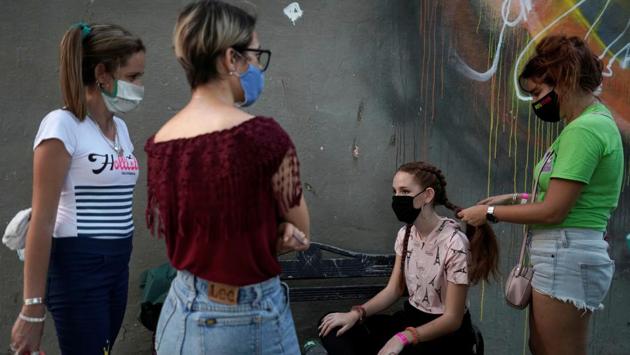 Thaidelen Gonzalez gets ready prior to a photo session for her quinceanera celebration amid coronavirus disease. (REUTERS/Alexandre Meneghini)
