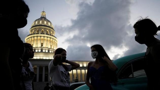 Estefani Linares gets ready for a photo session for her quinceanera (coming of age of 15-year-olds) celebration amid coronavirus disease (Covid-19) spread concerns, in Havana, Cuba. (REUTERS/Alexandre Meneghini)